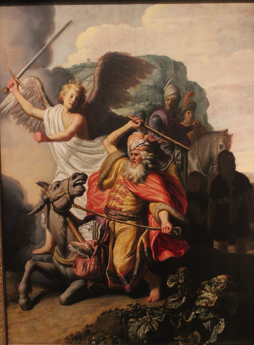 Rembrandt's Balaam and the ass: the prophet raises his staff over the balking donkey as the angel with drawn sword blocks the mountain path.