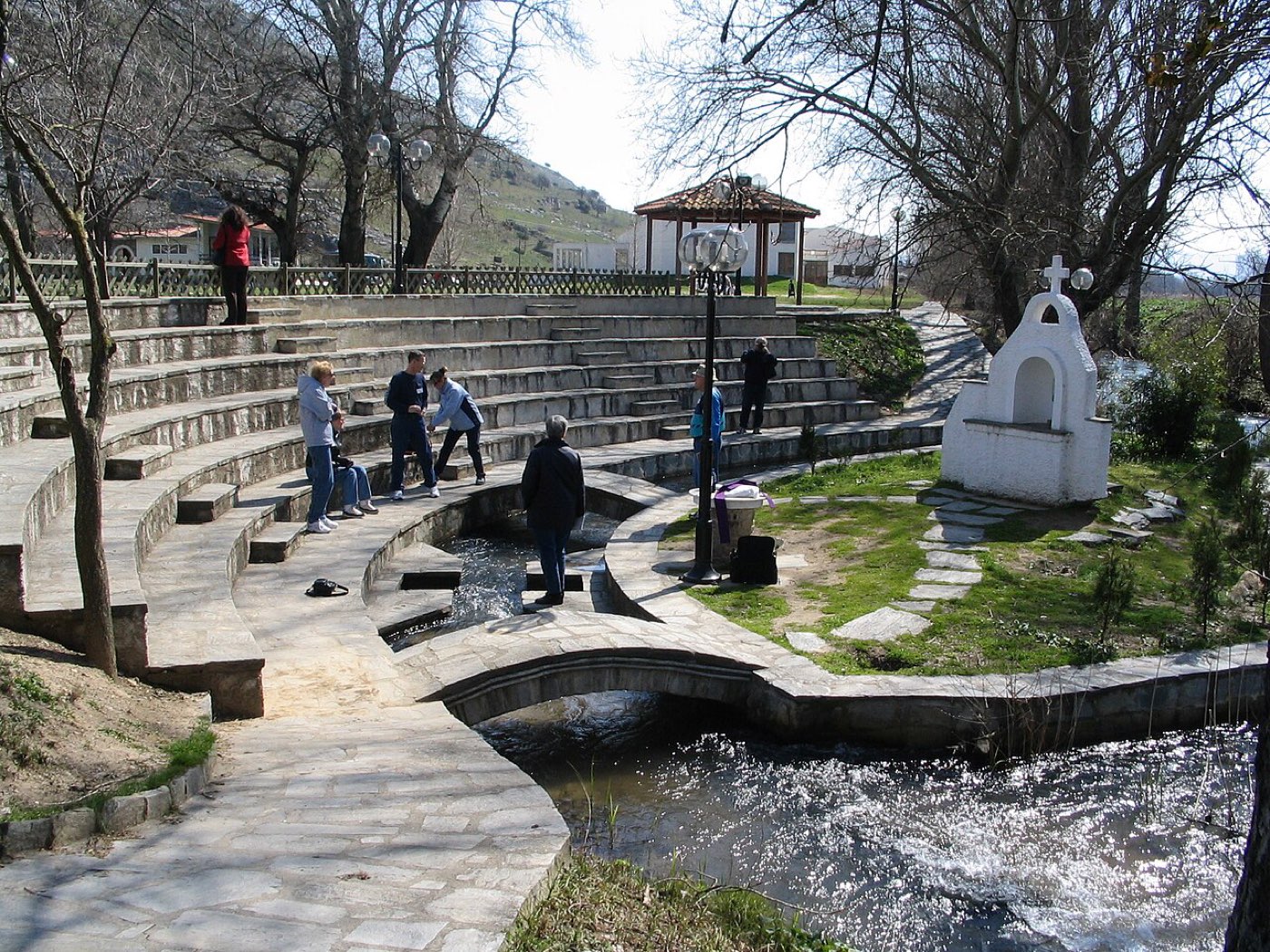 An ancient cross-shaped baptismal font cut into the ground among the ruins of Philippi.