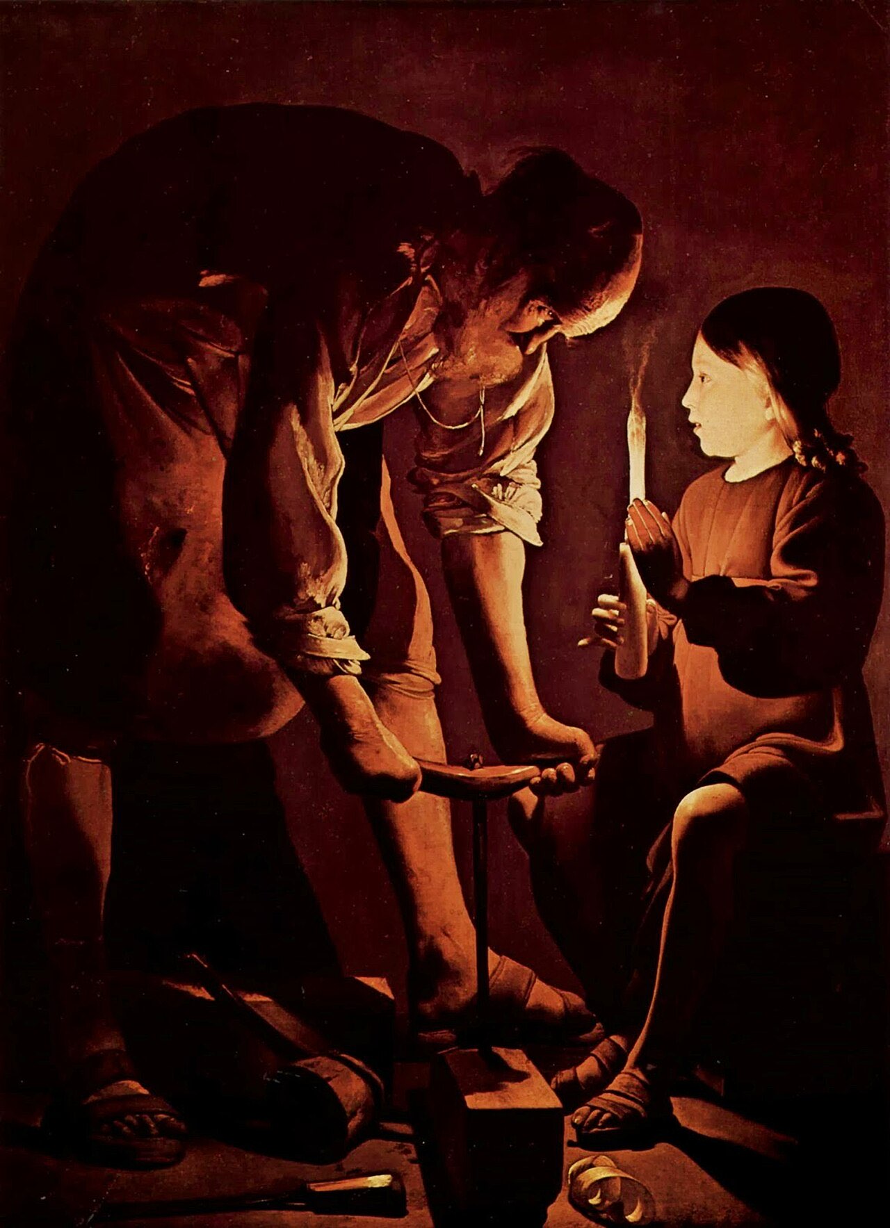 La Tour's candlelit painting of Joseph the carpenter bending over his auger while the boy Jesus holds the candle, its light glowing through the child's fingers.