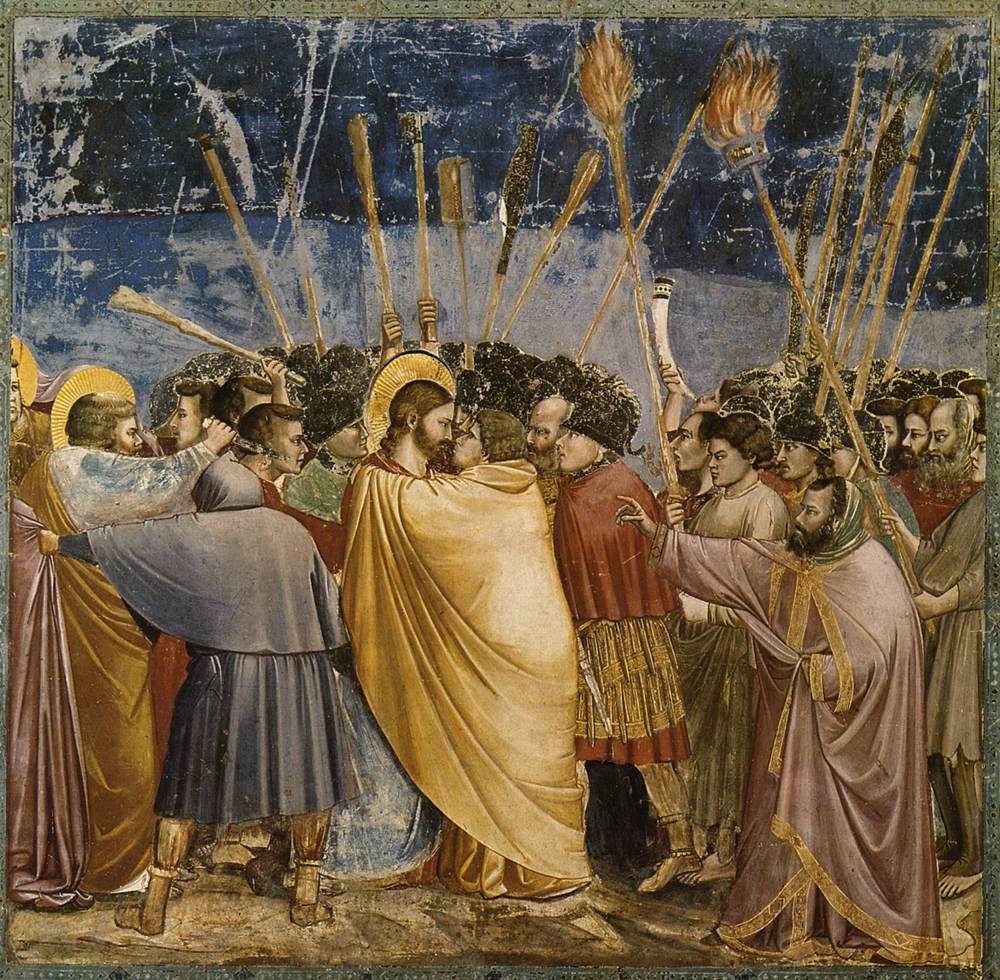 Giotto's fresco of the arrest: amid torches and spears, Judas wraps his yellow cloak around Jesus and leans in to kiss him while their eyes lock.