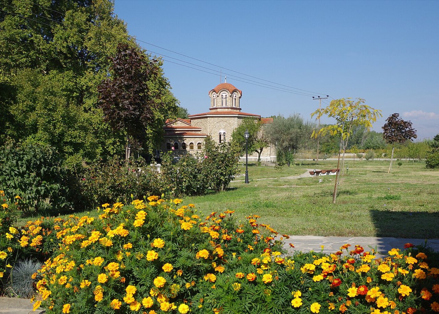 The modern octagonal baptistery of Saint Lydia near Philippi, standing among trees beside the river traditionally identified with her baptism.