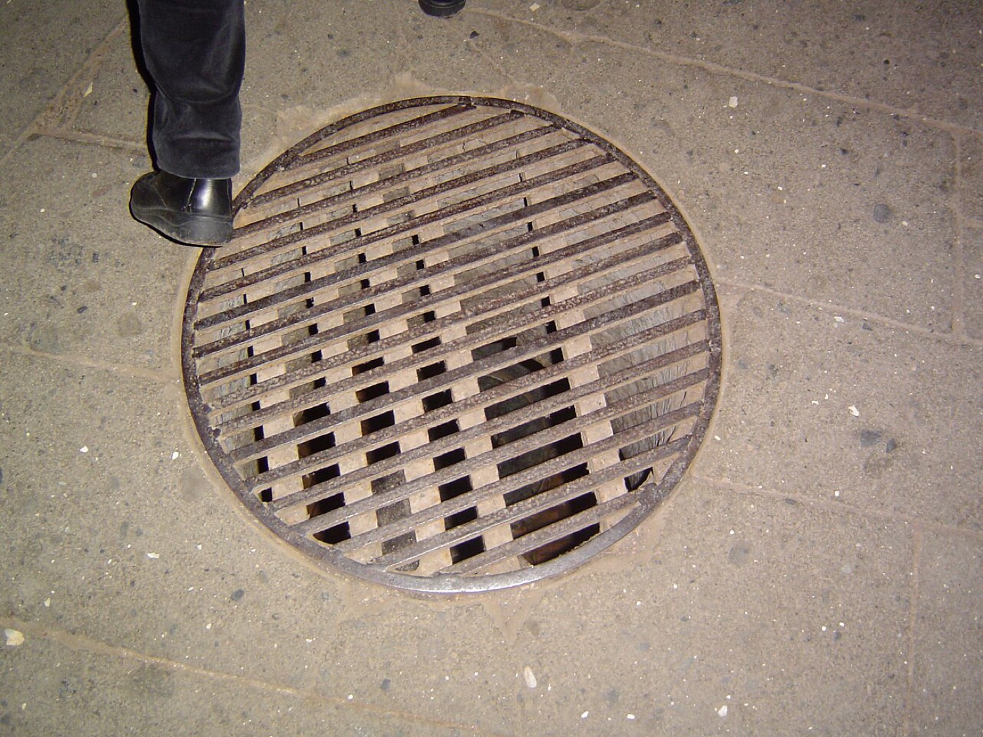 The round stone opening in the floor of Rome's Mamertine prison, the hole through which prisoners were lowered into the lower cell.