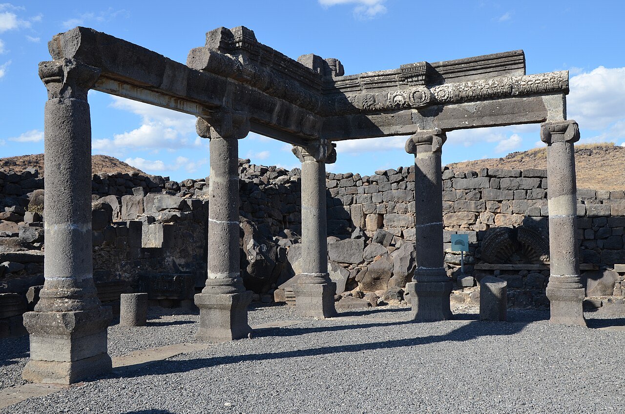 The reconstructed columns and carved black basalt walls of the ancient synagogue at Chorazin.