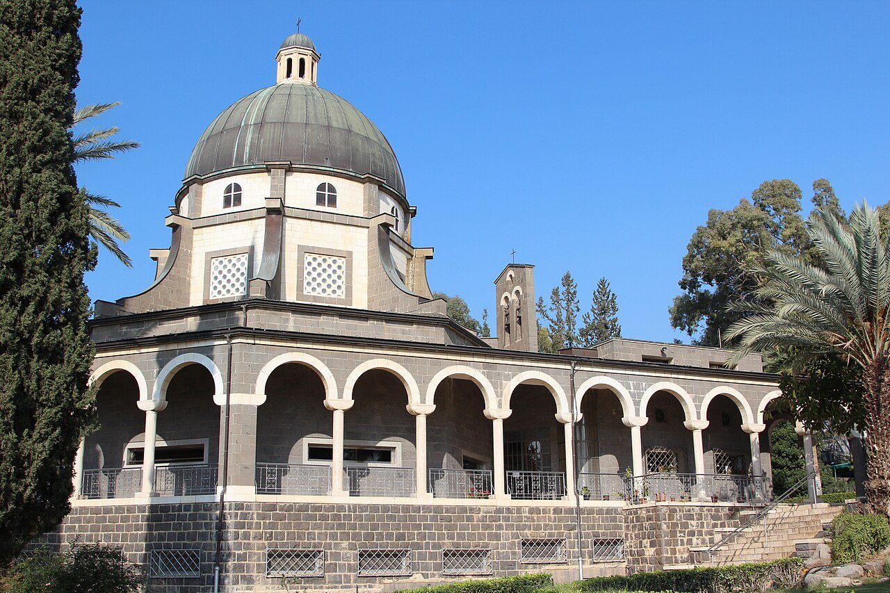 The octagonal Church of the Beatitudes with its dark dome and arched colonnade, set among cypress trees and gardens on the hillside.