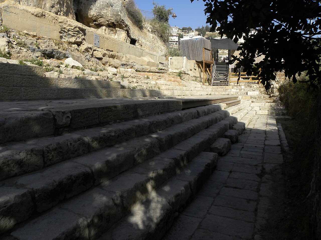 Broad stone steps of the excavated first-century Pool of Siloam, descending in wide tiers toward what was once the water.