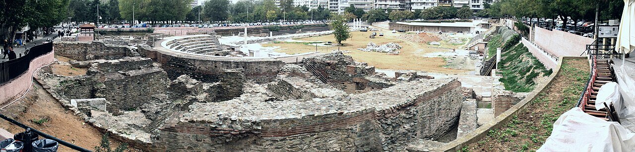 Wide view of the excavated Roman forum of Thessaloniki, sunk below the level of the modern city that surrounds it on every side.